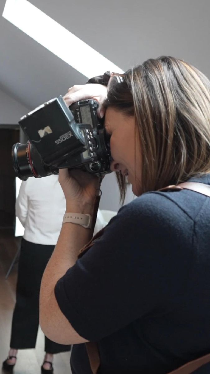 Jacqui looking through her camera during a shoot